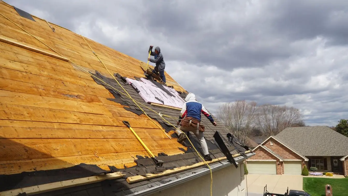 Roofing crew working on a residential roof